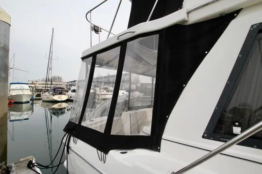 Slide: The Image of 1996 Bayliner 3788 Command Bridge Motoryacht docked in marina, featuring enclosed cockpit. - 7
