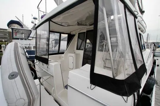 Slide: The Image of 1996 Bayliner 3788 Command Bridge Motoryacht with enclosed cockpit at marina. - 8
