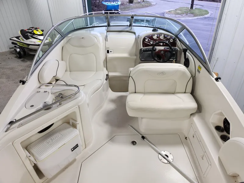 Slide: The Image of 2007 Monterey 250 Cruiser interior with white seating and steering wheel in a garage setting. - 11