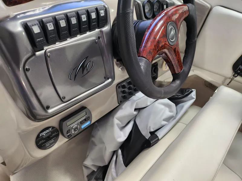 Slide: The Image of 2007 Monterey 250 Cruiser dashboard with wood-accented steering wheel and control panel. - 16