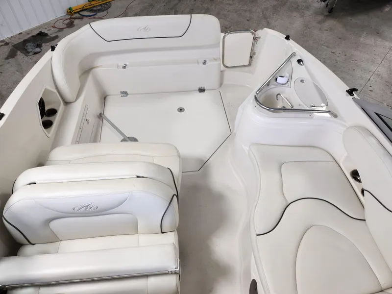 Slide: The Image of 2007 Monterey 250 Cruiser boat interior with white seating and sleek design. - 18