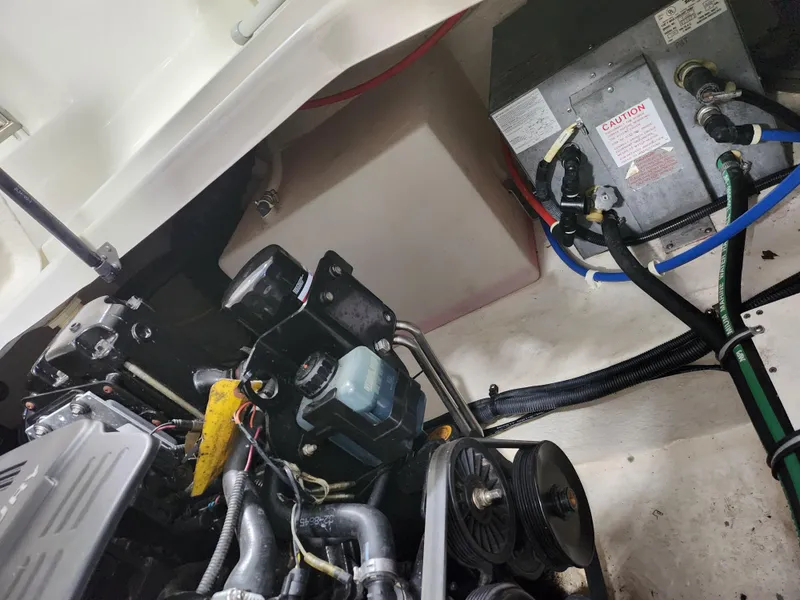 Slide: The Image of Engine compartment of a 2007 Monterey 250 Cruiser boat, showing mechanical components and wiring. - 20