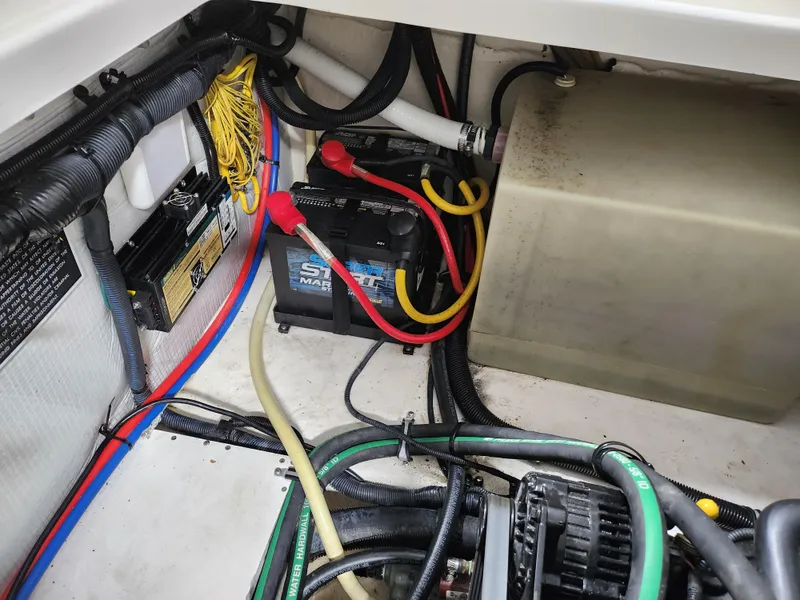 Slide: The Image of Engine compartment of 2007 Monterey 250 Cruiser with visible wiring and battery. - 21