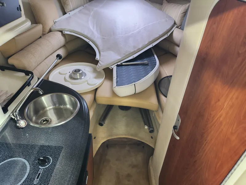 Slide: The Image of Interior of a 2007 Monterey 250 Cruiser boat with kitchenette and seating area. - 22