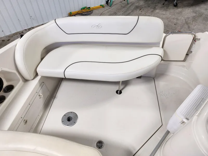 Slide: The Image of 2007 Monterey 250 Cruiser boat interior with white seating and cup holders. - 23