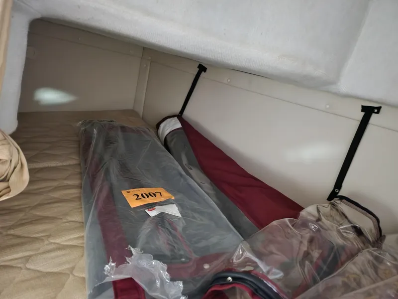 Slide: The Image of Interior cabin of a 2007 Monterey 250 Cruiser with stored items. - 25