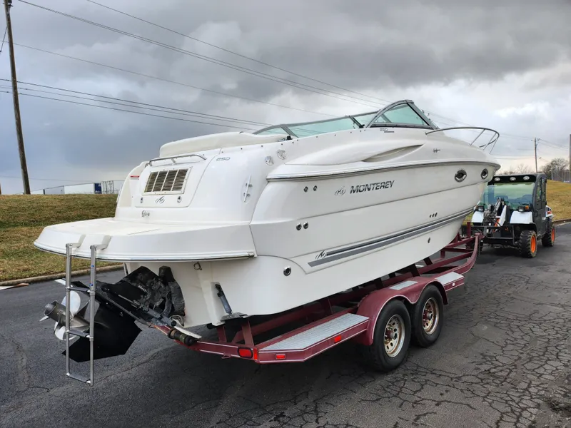 Slide: The Image of 2007 Monterey 250 Cruiser boat on trailer, overcast sky background. - 3