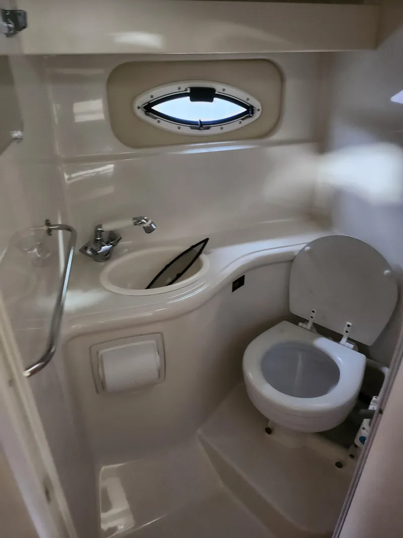 Slide: The Image of 2007 Monterey 250 Cruiser bathroom with sink, toilet, and porthole window. - 34