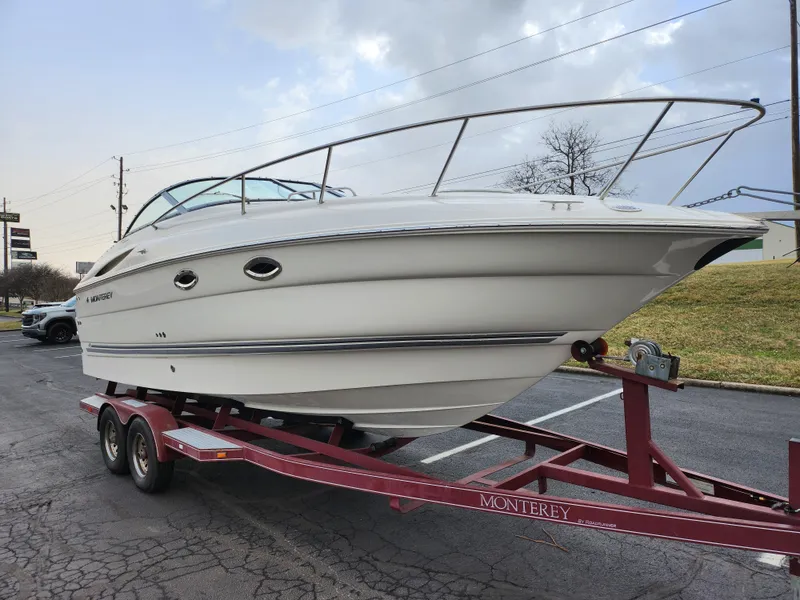 Slide: The Image of 2007 Monterey 250 Cruiser boat on trailer, parked outdoors. - 5
