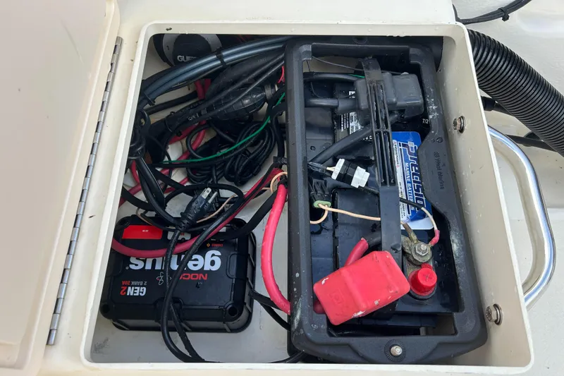 Slide: The Image of Boat battery compartment of a 2012 Parker 23 Special Edition, showing wiring and battery setup. - 10