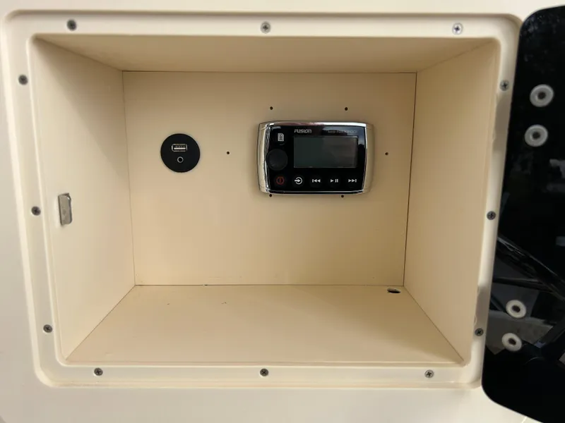 Slide: The Image of Storage compartment with USB port and control panel in 2012 Parker 23 Special Edition boat. - 17