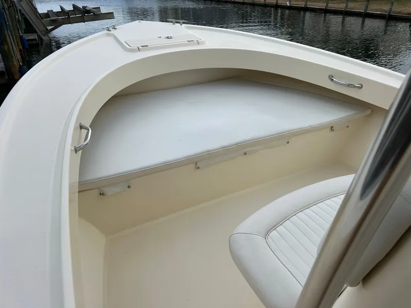 Slide: The Image of 2012 Parker 23 Special Edition boat interior with seating, dockside view. - 22