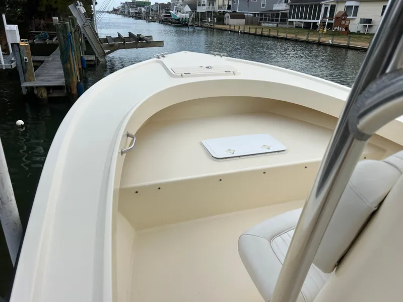 Slide: The Image of 2012 Parker 23 Special Edition boat docked by a waterfront, showcasing its sleek design. - 23