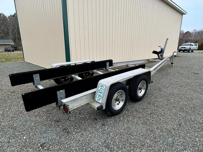 Slide: The Image of Trailer for Parker 23 Special Edition 2012, parked on gravel near a beige building. - 29