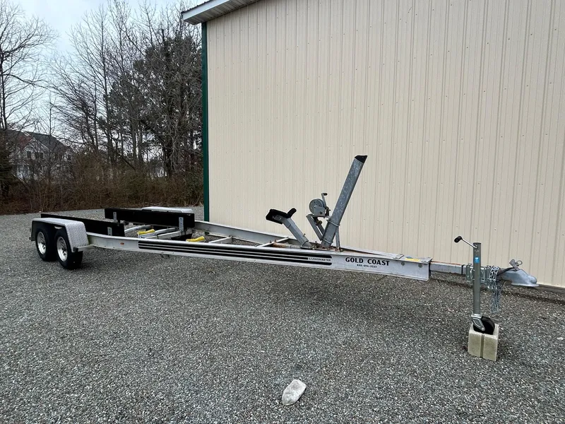 Slide: The Image of Trailer for Parker 23 Special Edition 2012, parked on gravel near a beige building. - 30