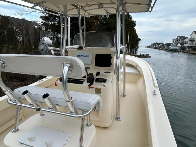 Slide: The Image of 2012 Parker 23 Special Edition boat on a calm canal, featuring a sleek console and seating. - 6