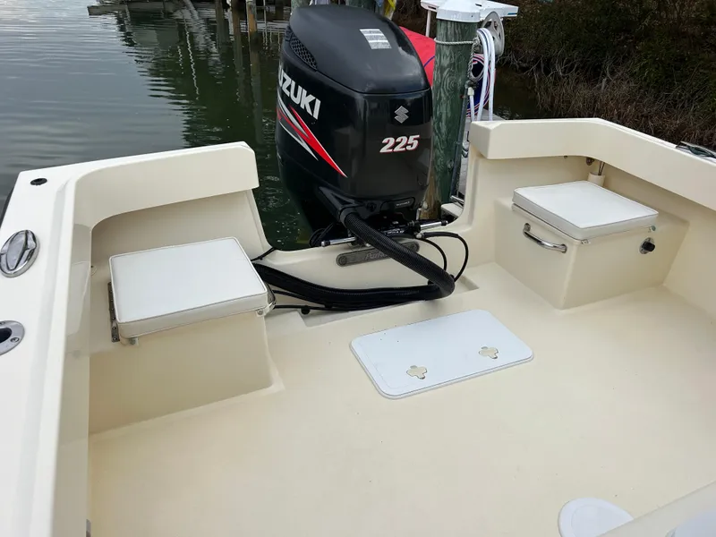 Slide: The Image of 2012 Parker 23 Special Edition boat with Suzuki 225 engine, docked on calm water. - 9