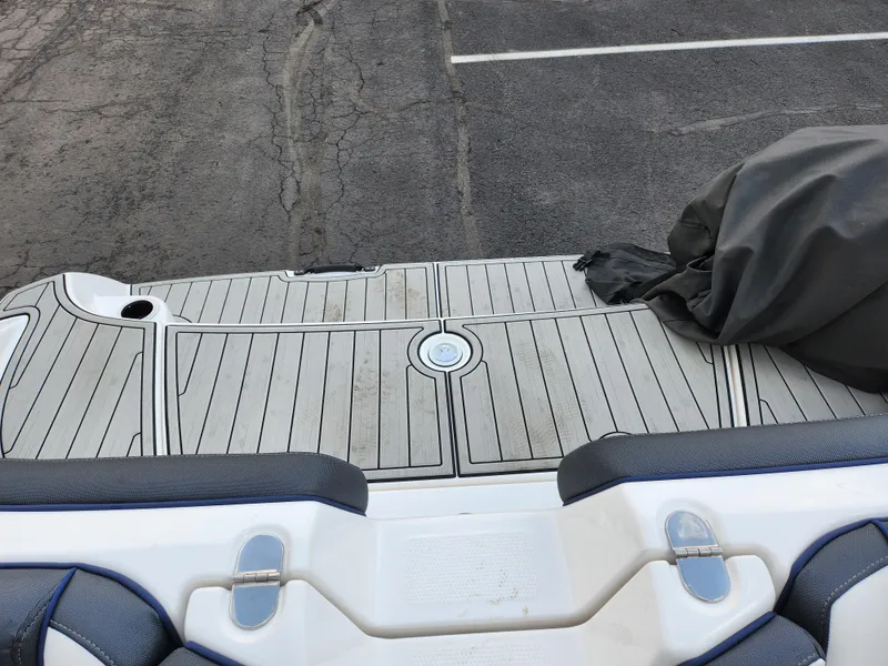 Slide: The Image of 2017 Yamaha Boats AR190 swim platform with cover, parked on asphalt. - 23