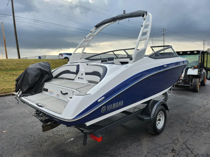 Slide: The Image of 2017 Yamaha Boats AR190 on trailer, blue and white design, parked outdoors. - 3