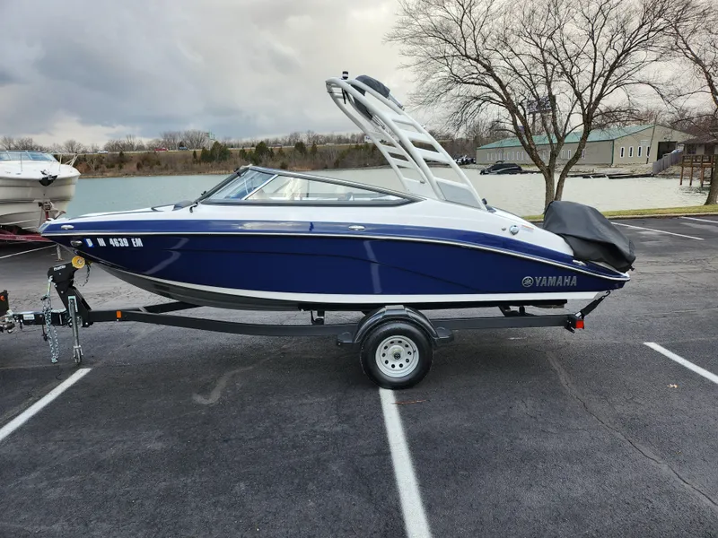 Slide: The Image of 2017 Yamaha AR190 boat on trailer, parked near a lake. - 9