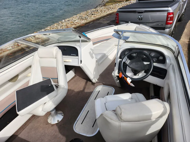 Slide: The Image of Interior of a 1994 Caravelle 1900 SE boat with white seating and steering wheel. - 11