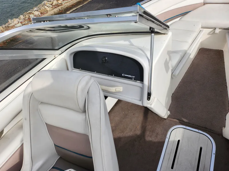 Slide: The Image of 1994 Caravelle 1900 SE boat interior with white seating and dashboard. - 14