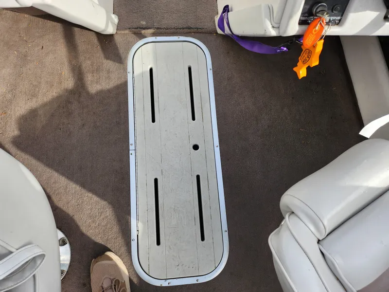 Slide: The Image of Interior of a 1994 Caravelle 1900 SE boat showing floor compartment and seating. - 15