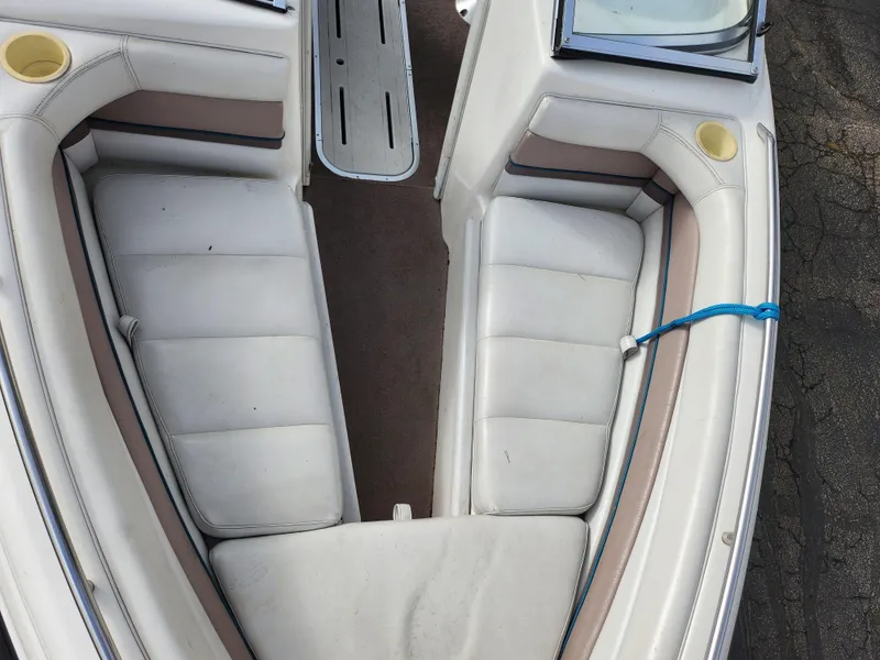 Slide: The Image of Interior view of a 1994 Caravelle 1900 SE boat with white cushioned seating. - 17