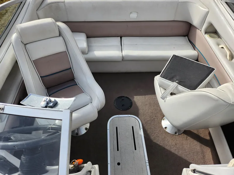 Slide: The Image of Interior of a 1994 Caravelle 1900 SE boat with seating and steering area. - 19