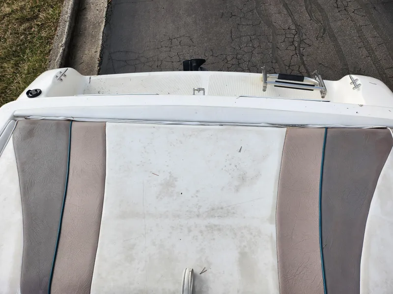 Slide: The Image of Rear view of a 1994 Caravelle 1900 SE boat with worn upholstery. - 21