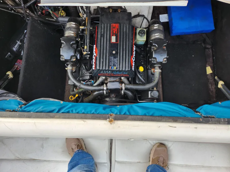 Slide: The Image of Engine compartment of a 1994 Caravelle 1900 SE boat, showing detailed mechanical components. - 22