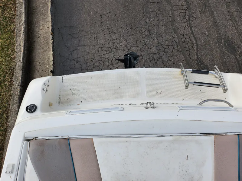 Slide: The Image of 1994 Caravelle 1900 SE boat, rear view, parked on cracked pavement. - 23