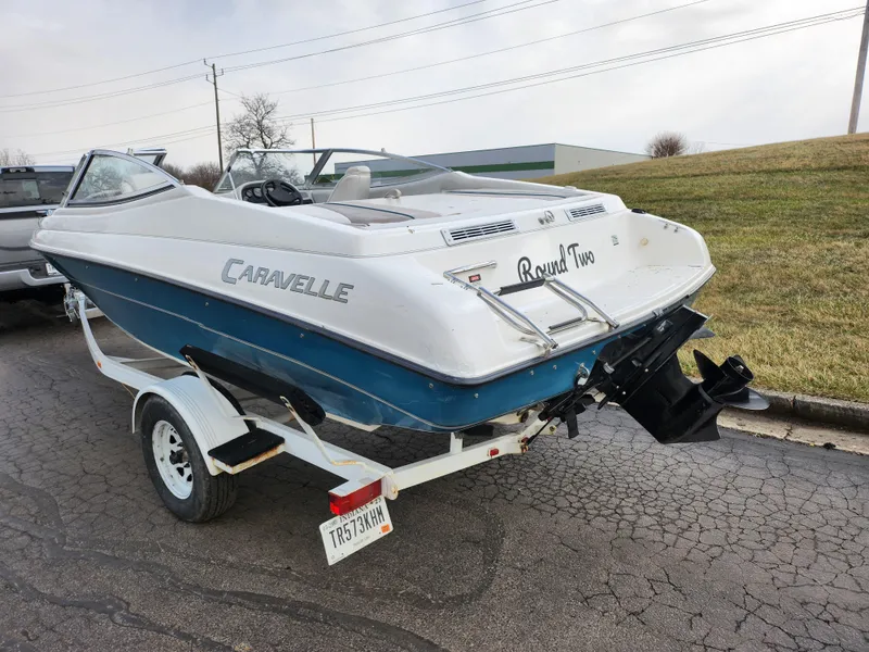 Slide: The Image of 1994 Caravelle 1900 SE boat on trailer, rear view, parked on paved road. - 3