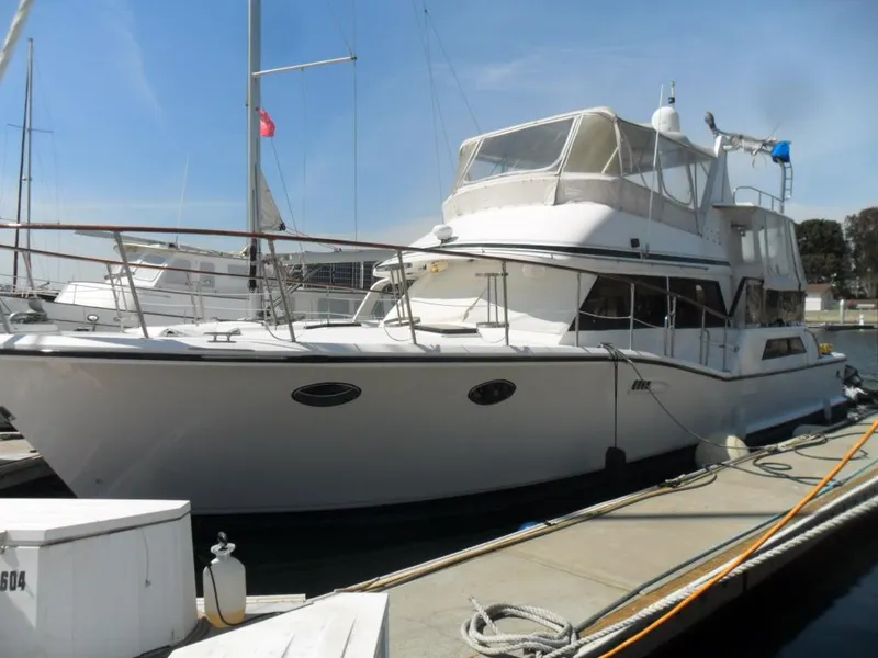 The Image of 1986 Symbol Yachtfisher docked at marina, featuring sleek design and spacious deck. - 0