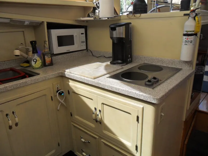 Slide: The Image of Compact yacht kitchen with microwave, coffee maker, and stove in 1986 Symbol Yachtfisher. - 15