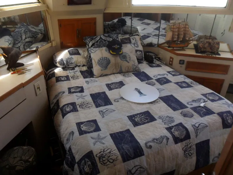 Slide: The Image of Cozy bedroom in 1986 Symbol Yachtfisher with nautical-themed decor and model ship display. - 22