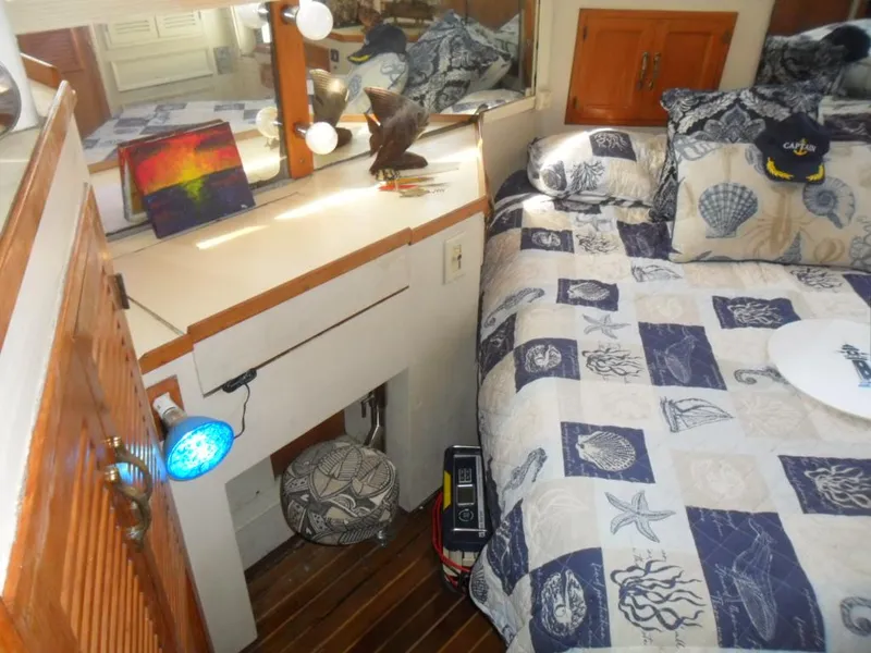 Slide: The Image of Cozy 1986 Symbol Yachtfisher cabin with nautical-themed bedding and decorative accents. - 23