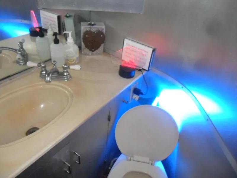 Slide: The Image of Bathroom on 1986 Symbol Yachtfisher with sink, toilet, and colorful lighting. - 25