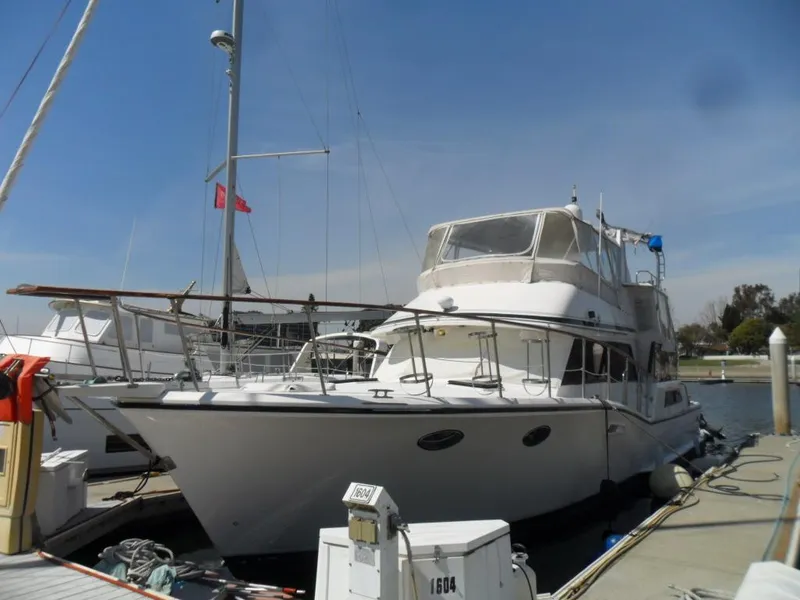 Slide: The Image of 1986 Symbol Yachtfisher docked at marina under clear blue sky. - 3