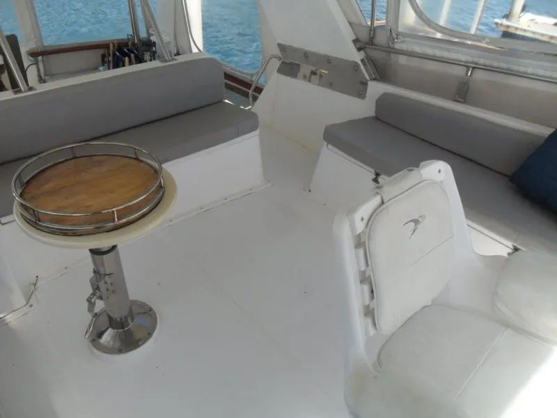 Slide: The Image of 1986 Symbol Yachtfisher interior with seating and table, overlooking the ocean. - 31