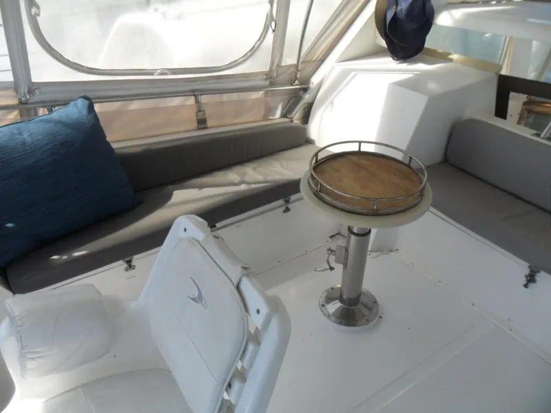Slide: The Image of 1986 Symbol Yachtfisher interior with seating, table, and window view. - 32