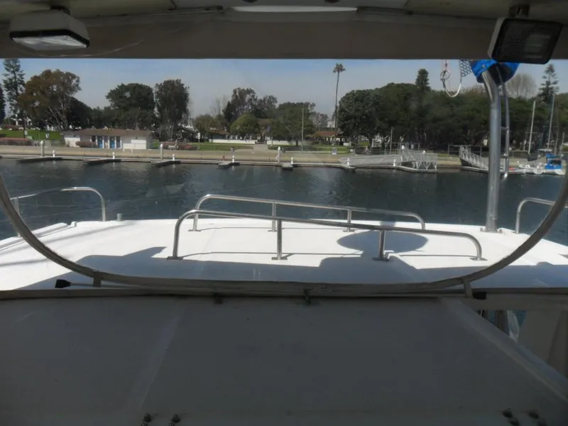 Slide: The Image of 1986 Symbol Yachtfisher docked at marina with scenic waterfront view. - 34