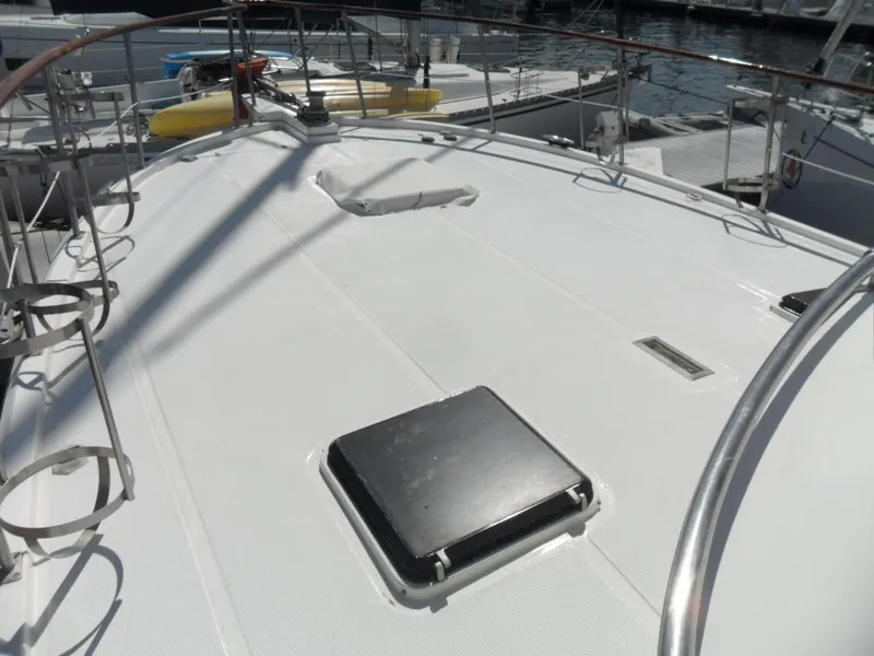 Slide: The Image of 1986 Symbol Yachtfisher deck with railing and hatch, docked at marina. - 36