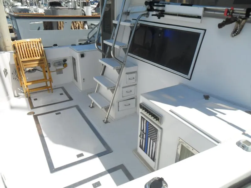 Slide: The Image of 1986 Symbol Yachtfisher deck with seating, storage, and fishing equipment. - 4