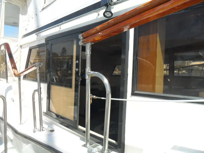 Slide: The Image of 1986 Symbol Yachtfisher exterior with polished railings and large windows. - 43