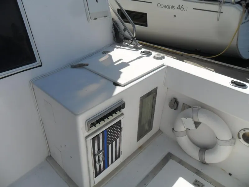 Slide: The Image of 1986 Symbol Yachtfisher deck with storage, life preserver, and American flag design. - 5