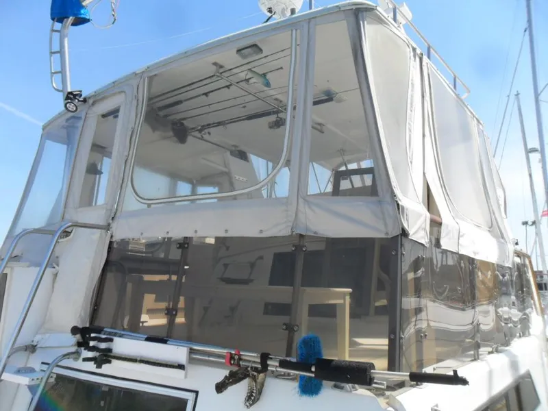 Slide: The Image of 1986 Symbol Yachtfisher with enclosed upper deck, featuring fishing rods and clear panels. - 6