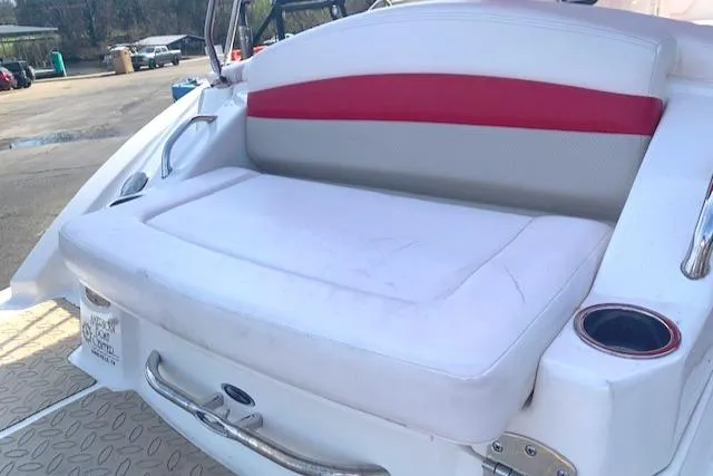 Slide: The Image of 2010 Chaparral Sunesta 224 boat seating area with white and red upholstery. - 5