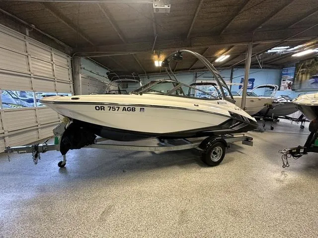 Slide: The Image of 2018 Yamaha AR195 boat in showroom, white exterior, on trailer. - 1