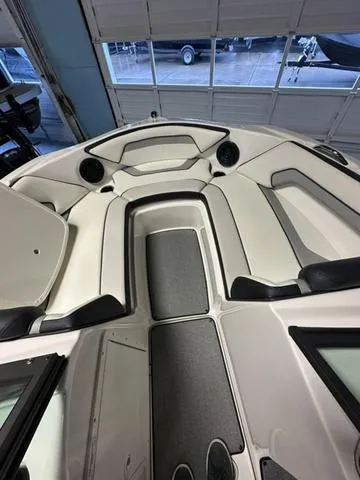 Slide: The Image of 2018 Yamaha Boats AR195 interior with seating and speakers in a showroom. - 11